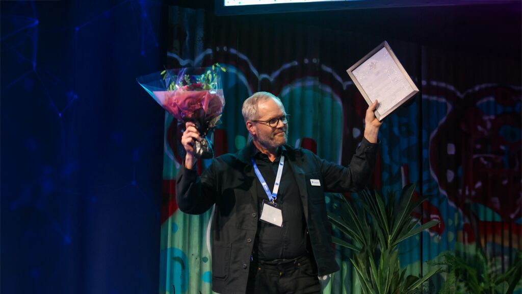 Winner celebrates on stage while receiving the Health Tech Award.